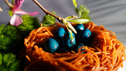 blue eggs in a nest of spaghetti