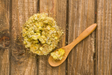 dried flowers immortelle on a wooden background