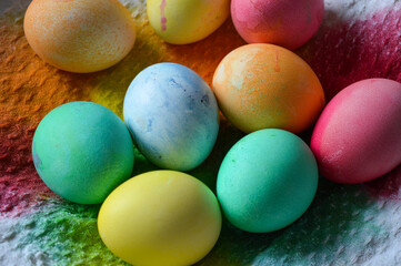 collection of vibrantly dyed Easter eggs textured cloth festive homemade celebration food cooking Easter themed tutorials natural food-safe egg dyeing methods background family traditions decorating 