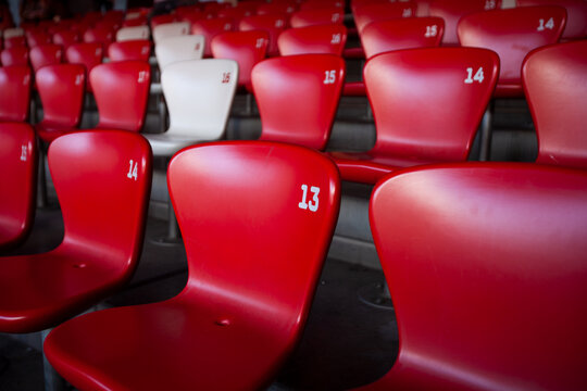 rows of red and white seats in stadium
