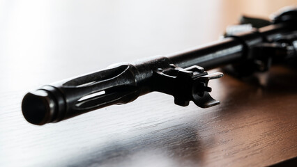 Kalashnikov assault rifle and cartridges on a wooden table