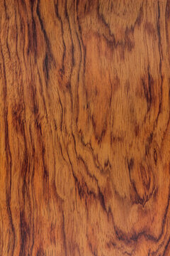 texture of valuable wood. wooden red board. lumber. bubinga, essingang, ebana, kevazingo, akume, waka, view from above. vertical texture. close-up.