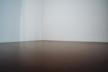 This stylish minimalist corner boasts a beautiful warm wooden floor complemented by soft light walls, creating an inviting and charming ambiance that enhances any home environment