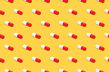 Pharmaceutical medicine pills. Capsule pattern isolated on yellow background. Medicine creative concept