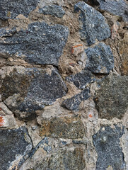 A close up of a stone wall with moss growing on it