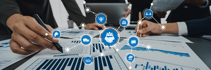 A dynamic office scene showcasing professionals engaged in collaboration and data analysis,...