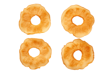 Four dried pineapple rings arranged on a  in a square formation for a food concept on transparent background png