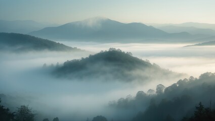 Fototapeta premium Rocky, forested hill rises from the valley in the mist. Stunning morning in the mountain scenery with mists. Morning fog.
