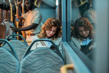 Businesswoman using smartphone on bus during commute