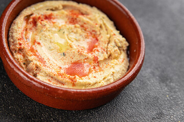 Hummus chickpea dip spices tasty appetizer vegetable dish fresh delicious gourmet vegetarian and vegan food background on the table rustic food top view copy space keto and paleo diet