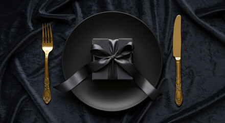 Golden cutlery VIP fine dining, black gift box on plate with silk ribbon on velvet. Engagement, Proposal, Black Friday, Cyber Monday, Valentine, Christmas Luxury, Loyalty, Milestone, Anniversary