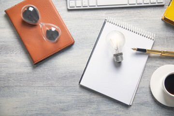 Light bulb with a business objects on the table.