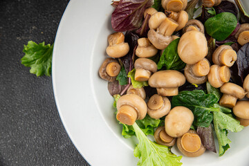Mushroom salad green lettuce canned champignon mushrooms fresh gourmet food background on the table rustic food top view copy space