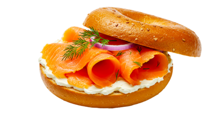 A bagel sandwich with cream cheese, salmon, dill, and red onion on a black background isolated shot