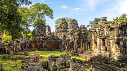 Fototapeta premium Forgotten in jungles ancient hindu Banteay Kdei khmer ruined temple decorated with statues, Angkor Archaeological Park, Siem Reap, Cambodia