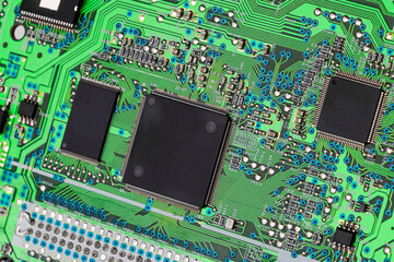 CD-ROM drive motherboard with green print and chip, close-up