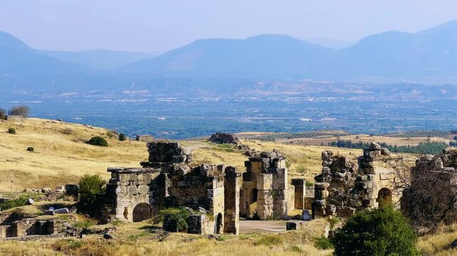 HIERAPOLIS in Denizli, TURKEY, August 13, 2024: The ancient city of Hierapolis near Pamukkale, against the backdrop of nature and mountains. The Phrygian period.UNESCO.4K