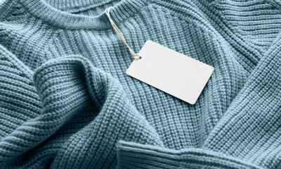 sky blue denim fabric with white label and striped details in a close-up view.