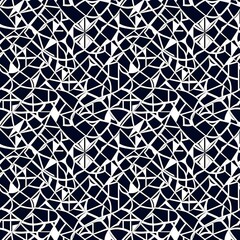 a black and white geometric pattern on a dark background