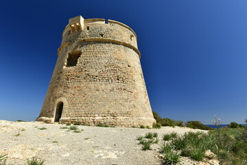 Naklejka premium Torre Des Carregador, Ibiza, Balearic Islands. 19th century tower at the end of Playa De Bossa beach.