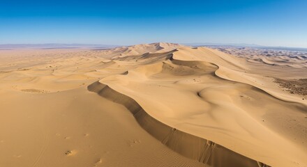 Majestic Sand Dunes Under Azure Sky - Aerial view of expansive sand dunes stretching to the horizon under a vibrant blue sky. Symbolizing freedom, vastness, adventure, serenity, and timelessness