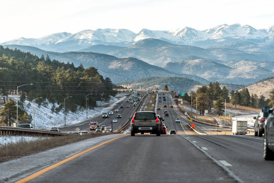 Colorado interstate i70 road in Denver Golden with exit sign and traffic jam from snow capped mountains ski season