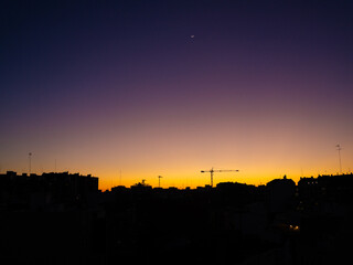 City skyline at dusk with purple and orange sky © Stoca