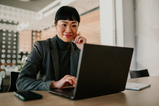 Businesswoman working on laptop in modern office