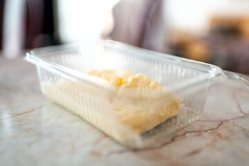 Famous local cheese from market deli called Pljevaljski sir with macro view of texture of soft aged raw product