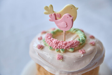 Captivating, springtime elegance radiates from this beautiful bird-topper cake, a whimsical dessert perfect for celebrations, baby showers, or a gentle touch of delight, conveying peaceful emotions.