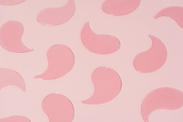 Pattern pink hydrogel patches on pink isolated background. Concept of beauty products, care and moisturizing for the skin around the eyes, dark circles and wrinkles