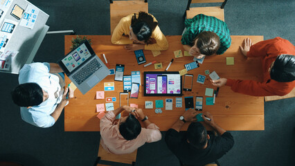 Top view of developer team working together to write idea about Ux Ui design on whiteboard. Smart...
