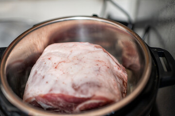 Pork shoulder picnic pig fat meat cut raw uncooked food in kitchen saucepan pot macro closeup