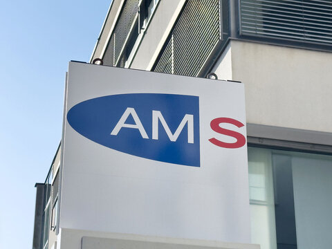Ams company logo on building exterior with modern architectural features