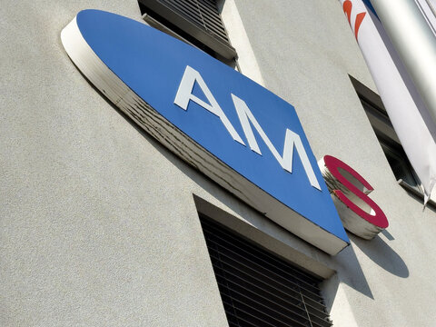 Close-up of corporate building with ams logo sign and exterior details