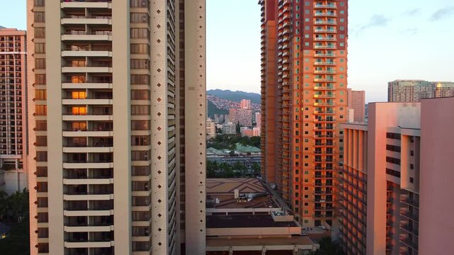 Urban sunset light between high-rise buildings in Honolulu, Golden hour view between tall apartment towers in Honolulu, Hawaii