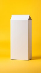 Naklejka premium An empty white carton stands upright against a vibrant yellow backdrop, highlighting its modern and sleek design. Ideal for various beverage or food products