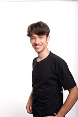Portrait of handsome young man with straight hair smiling and looking at camera. Calm and happy person.