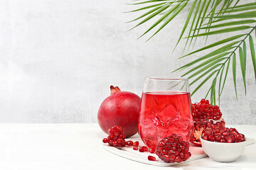 Fruit juice and ingredients, summer drink or tonic with pomegranate and ice on bright table, detox diet and weight loss concept, healthy and natural food, source of vitamin C, selective focus
