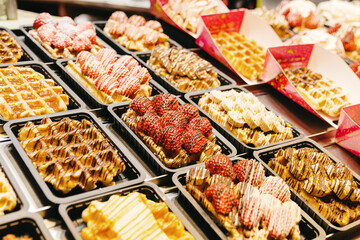 Filled Belgian waffles on display in a shop window.