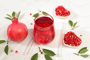 Fruit pomegranate juice and ingredients, summer pomegranate drink on bright table, detox diet and weight loss concept, healthy and natural food, source of vitamin C, selective focus, space for text.