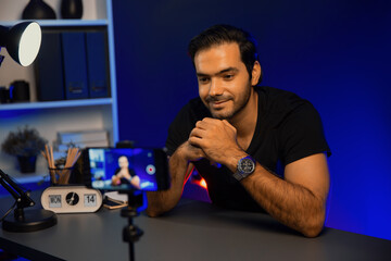 Broadcaster talking to listener on live streaming online, recording by smartphone setting on social...