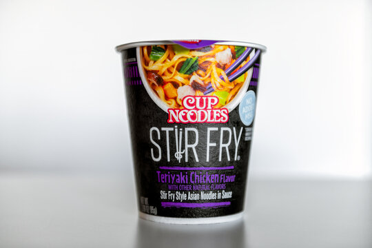 Destin, USA - March 5, 2023: Cup Noodles brand ramen noodle instant soup bowl asian meal with sign for teriyaki chicken flavor stir fry