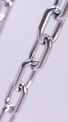 Intricate details of a polished metal chain showcased against a simple backdrop