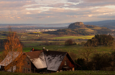 Scenic countryside landscape with a hilltop castle in the background during golden hour