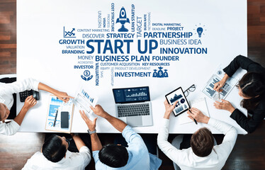 Engaging top view shot of a diverse startup team working together on a business strategy in a modern office setting, showcasing collaboration and innovation. Amity