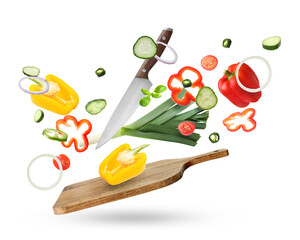 Cutting board, knife and fresh vegetables in air on white background