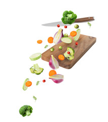Cutting board, knife and fresh vegetables in air on white background