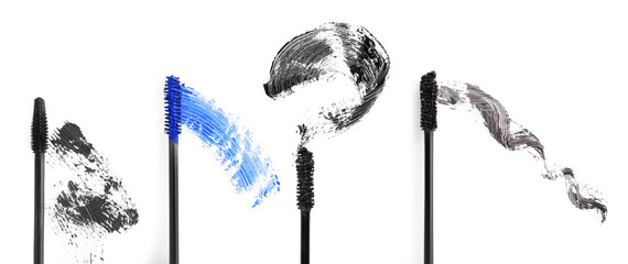 Different mascara strokes and brushes on white background, set. Top view