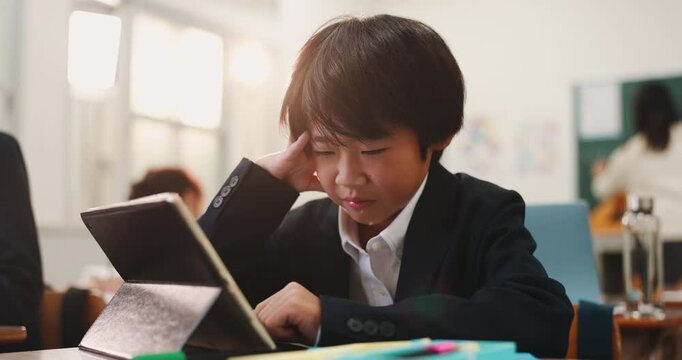 Boy, tablet and kid stress in class, online and frustrated with digital quiz or assignment. Male person, adhd and mental burnout at school in Japan, elearning and tired of education or brain fog